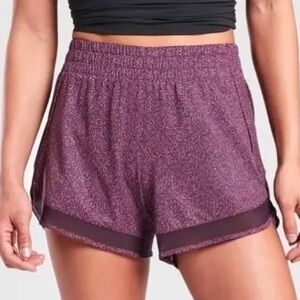 Athleta Racer Run shorts size Small. Violet static.